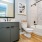 bathroom with a large mirror and ample lighting