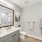 bathroom with a large mirror and ample lighting